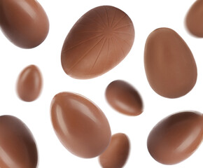 Sweet chocolate Easter eggs falling on white background