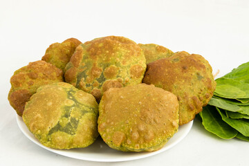 Closeup Of Delicious Indian Palak Poori Or Paalak Puri Made Of Whole Wheat Flour Gehoon Ka Aata Mixed With Blenched Fresh Spinach Leaves Served In Plate. White Background With Copy Space