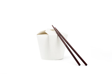 chopsticks and cardboard food box on white background