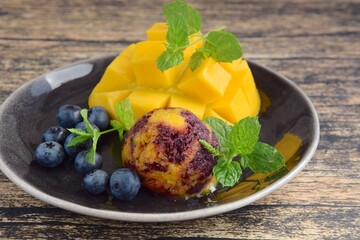 Homemade mango blueberry sorbet garnish with mint leaf