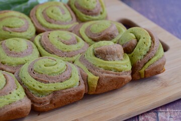 Matcha chocolate bread rolls on wooden board
