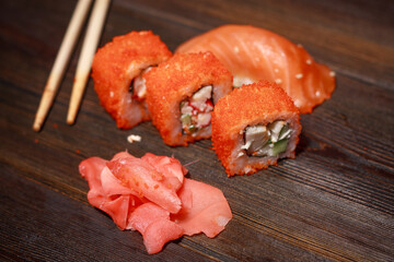 asian cuisine sushi and rolls on the table wooden sticks ginger wasabi