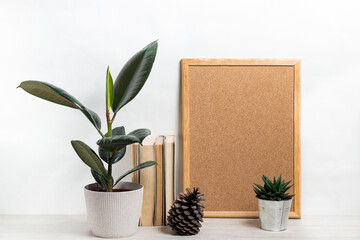 Poster with copy space. Mockup of a wooden frame with home plant ficus and cactus in pods. Scandinavian-style interior. White, minimalism. copy space