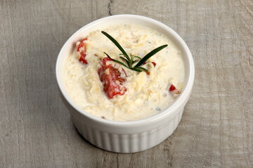 One pot with casserole - sour cream, tomatoes and fish or other ingredients before baking. dishes with unroasted julienne