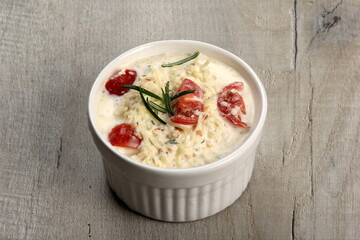 One pot with casserole - sour cream, tomatoes and fish or other ingredients before baking. dishes with unroasted julienne