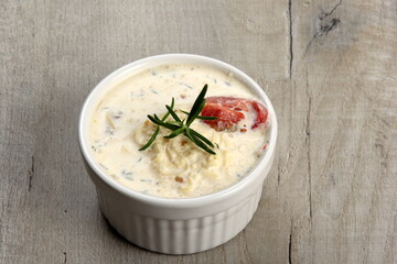 One pot with casserole - sour cream, tomatoes and fish or other ingredients before baking. dishes with unroasted julienne
