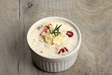 One pot with casserole - sour cream, tomatoes and fish or other ingredients before baking. dishes with unroasted julienne