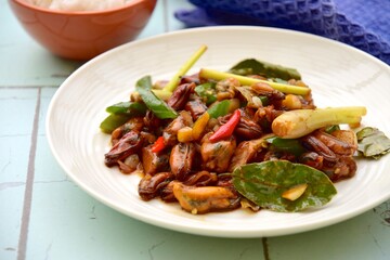 Oseng Kerang Saus Tiram, Indonesian food. Stir-fried mussels with oyster sauce, soy sauce, lemongrass, bayleaf, ginger, garlic and chili.