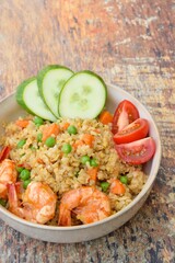Nasi Goreng or Fried rice with carrot, peas, king prawns, tomato and cucumber
