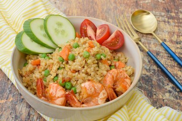 Nasi Goreng or Fried rice with carrot, peas, king prawns, tomato and cucumber
