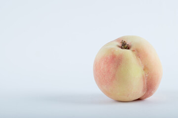 Single fresh peach located on white background