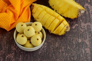 Homemade Indonesian pineapple tart cookies or Nastar served to celebrate Idul Fitri or Eid al Fitr. Wooden background