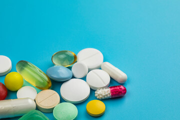 Multicolored tablets on blue background. Health care concept.