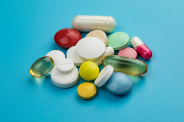 Multicolored tablets on blue background. Health care concept.