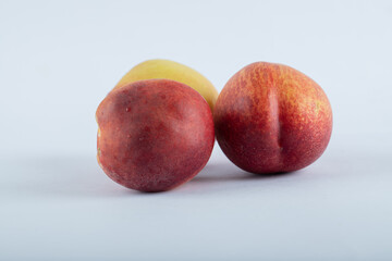 Three fresh nectarines located on white background