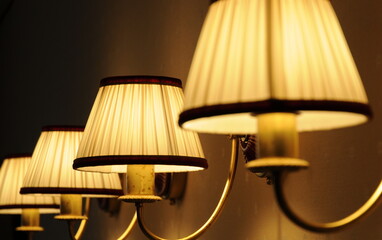 Close-up of a decorative element of the interior - four overhead lamps (sconces) on the wall....
