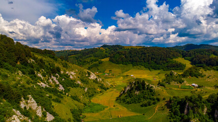 Fototapeta premium view from the hill with the green valley and the hollow rocks without trees