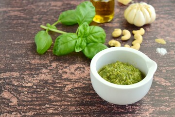 Basil pesto made from basil leaves, olive oil, parmesan cheese, pine nuts, garlic, salt and pepper

