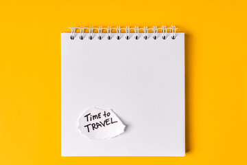 The inscription TIME TO TRAVEL on an empty notebook and a beautiful composition for the theme of travel. Copy space