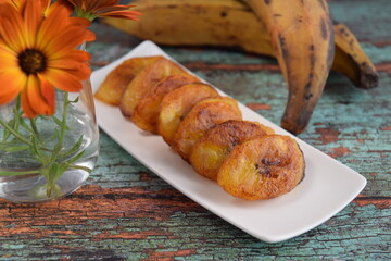 Fried slices of ripe plantains, traditional and popular snack in Central America and Northern South America. Platanos Maduros Fritos © AmalliaEka