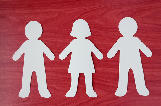 Paper cutout of a man, woman and man