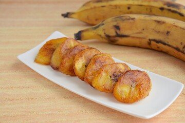 Fried slices of ripe plantains, traditional and popular snack in Central America and Northern South America © AmalliaEka