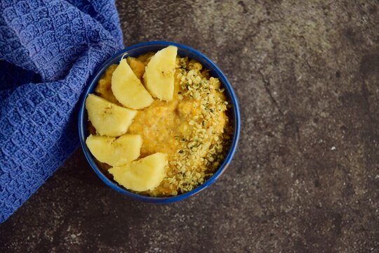 Healthy pumpkin porridge with banana and hemp seeds