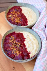 Breakfast oatmeal porridge with berry sauce and bee pollen
