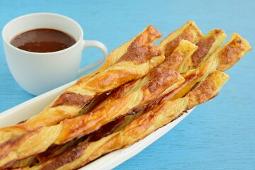 Cinnamon sugar puff pastry sticks with chocolate sauce dip