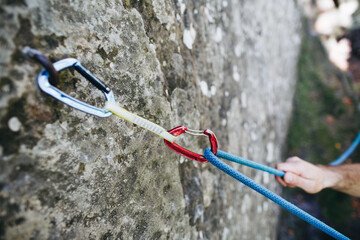 Quickdraw with rope on the rock. Climbing and mountaineering equipmenton the route