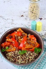 Cooked red and white quinoa with sweet potato, raisin, bell pepper, sesame seeds and parsley. Healthy vegan food
