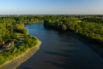 Fototapeta premium Aerial view of the Scheldt river, while passing the picturesque village of Vlassenbroek