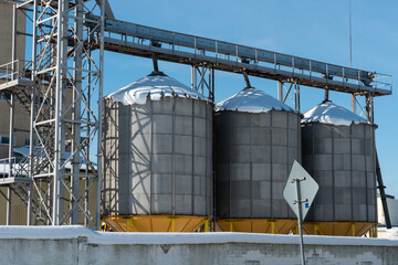 silver silos on agro manufacturing plant for processing drying cleaning and storage of agricultural...