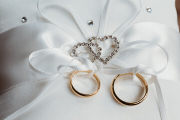 two wedding rings wrapped in a ribbon
