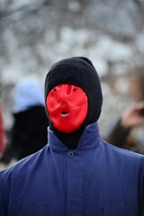 unrecognizable man with red mask 