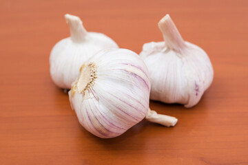  garlics on a wooden table.