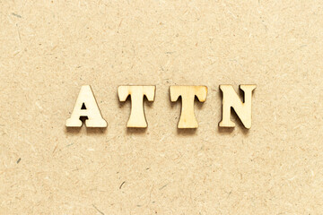 Alphabet letter in word ATTN (Abbreviation of attention)  on wood background