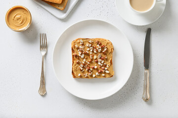 Crispy toast with peanut paste for breakfast on white background. View from above.