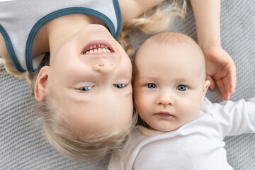 Close portrait of brother and sister. Top view