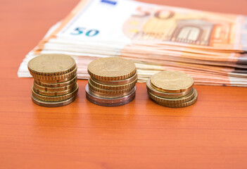 Fifty euro banknotes and coins.