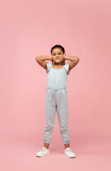 Fototapeta na wymiar Jumping. Happy longhair brunette little girl isolated on pink studio background with copyspace for ad. Looks happy, cheerful, sincere. Childhood, education, human emotions, facial expression concept.