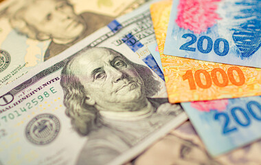 Money, Argentine pesos ( ARS ). A group of Argentine money banknotes and US Dollars. Photograph to...