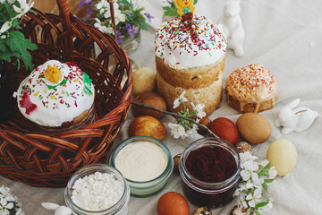 Traditional Easter food, homemade Easter bread,  easter eggs and spring flowers on rustic table