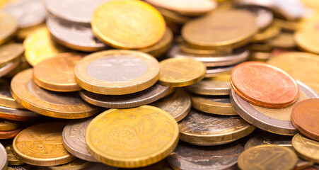 Different money coins. Money US dollars and euros on a white background. Savings and savings. Coins of different nominal from different countries.
