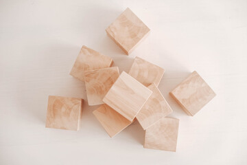 Stack wooden blocks from natural wood on a white background. Top view. Copy, empty space for text