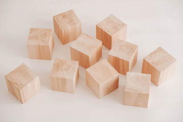 Wooden cubes from natural wood on a white background. Copy, empty space for text