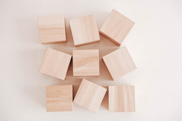 Wooden cubes from natural wood on a white background. Top view. Copy, empty space for text