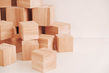 Stack wooden blocks from natural wood on a white background. Copy, empty space for text