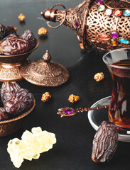 Ramadan concept with cup of tea and dried dates