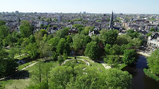 Aerial view of Vondelpark in Amsterdam, Netherlands. Famous place in dutch city to visit. Public park during spring or summer season, sunny day.